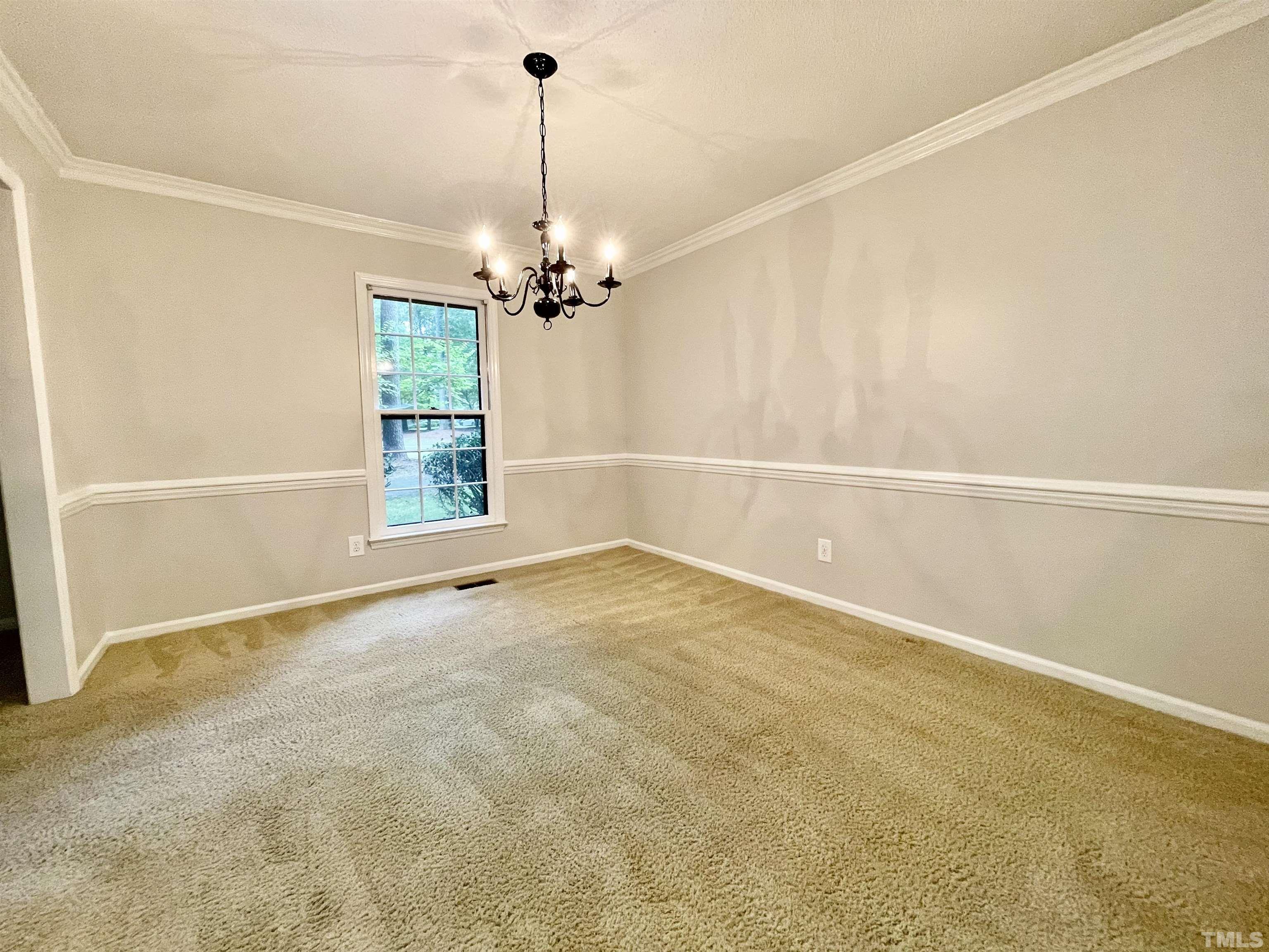 3100 Shadwell Court Raleigh, NC 27613 - Photo 8 of 30 a view of an empty room with a chandelier