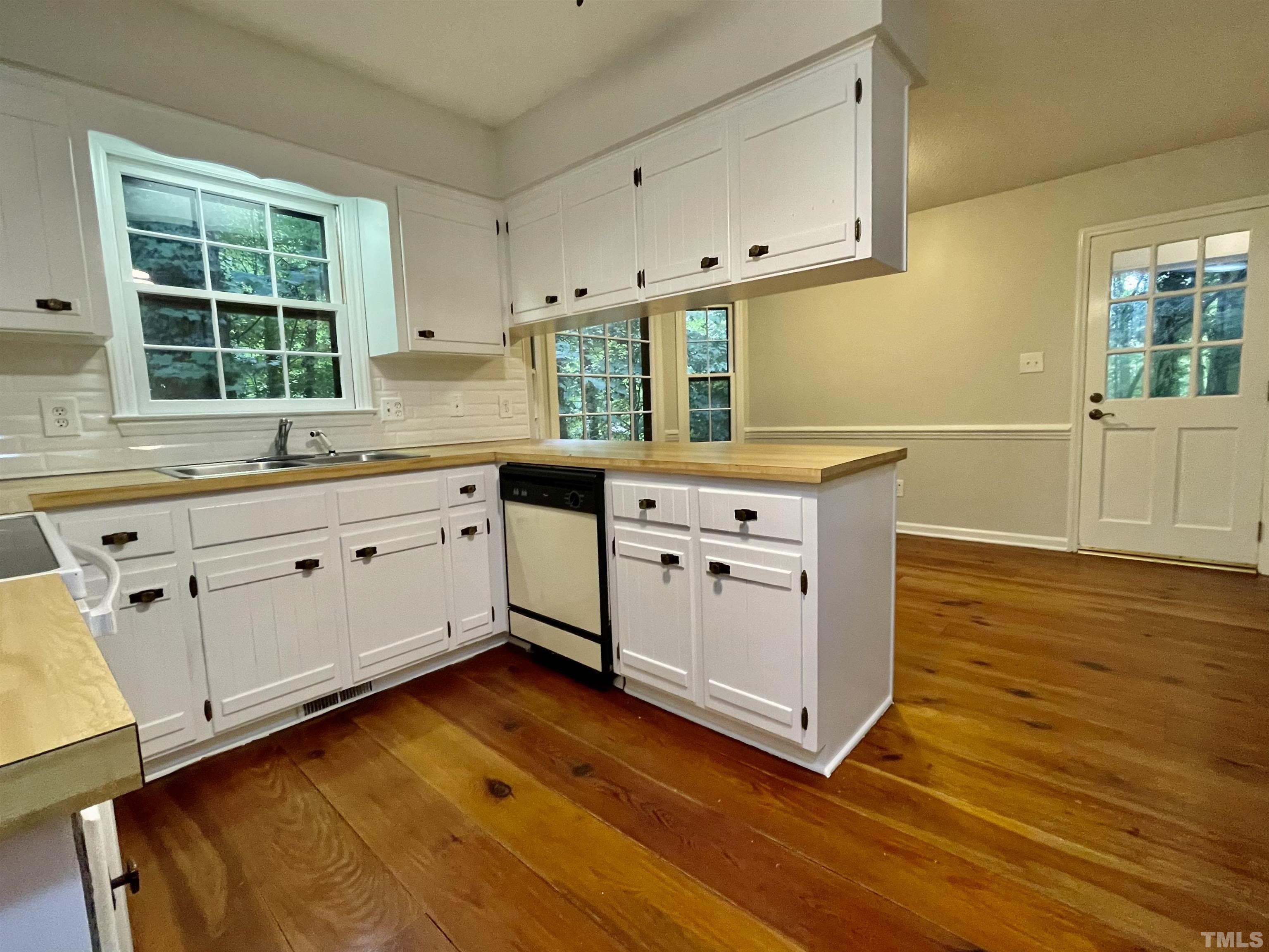 3100 Shadwell Court Raleigh, NC 27613 - Photo 10 of 30 a kitchen with a sink stove and cabinets