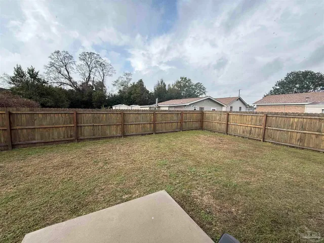 a view of outdoor space with wooden fence