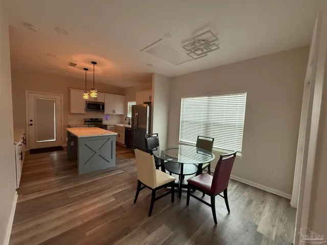 a view of a dining room with furniture window and wooden floor