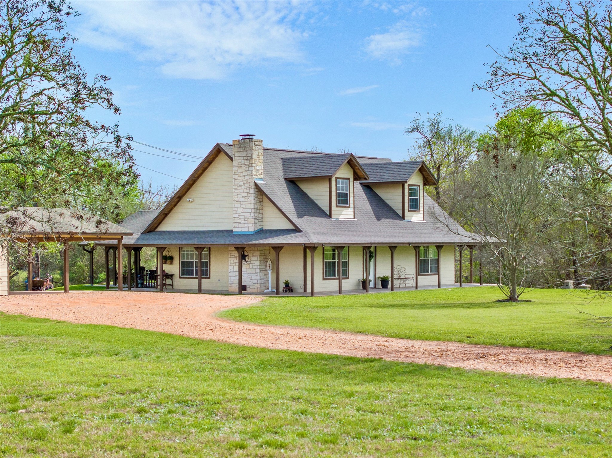 a front view of a house with a yard and trees