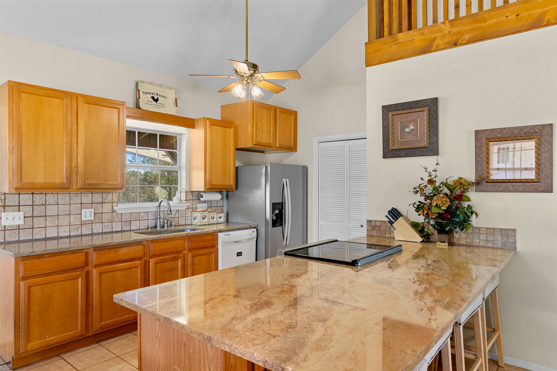 999 Salem Road Brenham, TX 77833 - Photo 28 of 40 a kitchen with stainless steel appliances kitchen island granite countertop a sink and cabinets