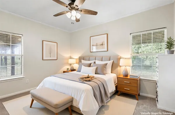a spacious bedroom with a bed and a chandelier