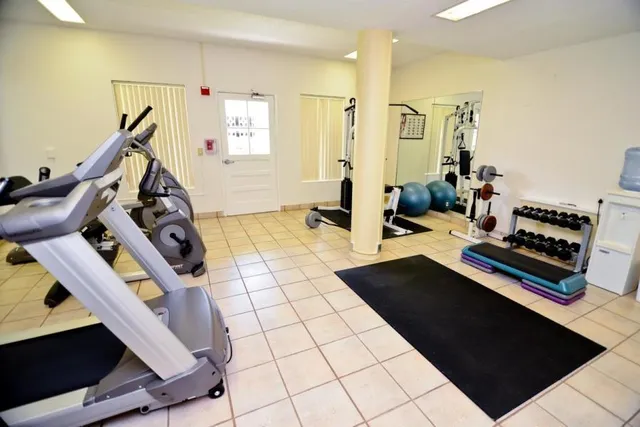 a room with pool table and windows