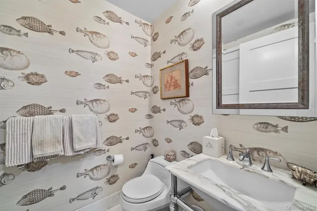 a bathroom with a sink toilet and mirror