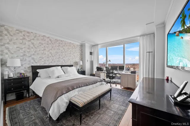 a bedroom with a bed window and a desk