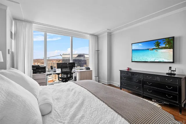 a bed room with furniture and a flat screen tv