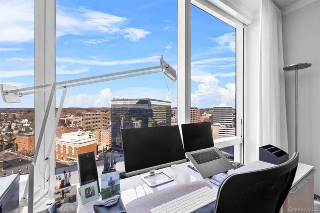 a view of a balcony with chair and city view