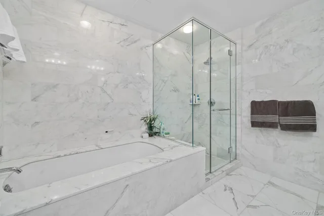 a spacious bathroom with a bathtub and a shower