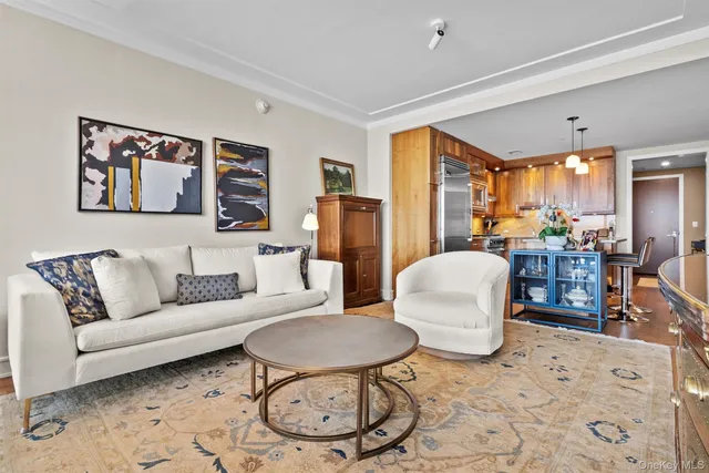 a living room with furniture a large window and dining table