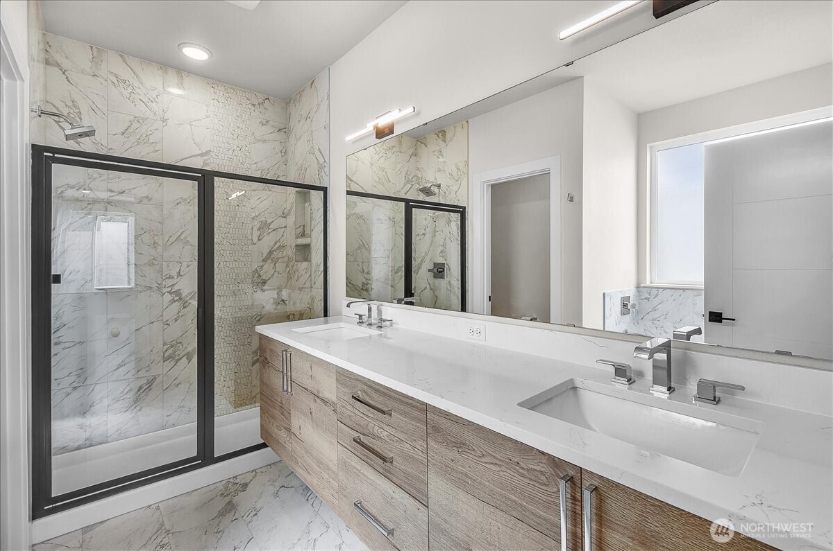 8922 Northeast 173rd Place, Unit A Bothell, WA 98011 - Photo 11 of 26 a bathroom with a double vanity sink mirror and shower