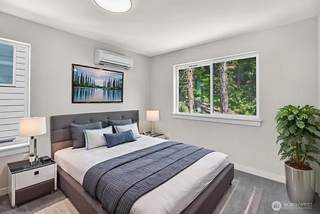 a bedroom with bed and a potted plant