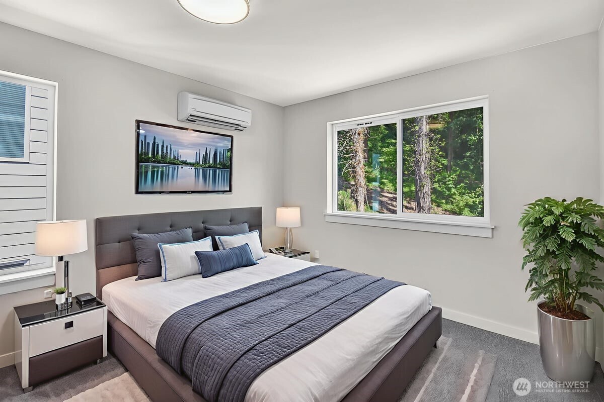 8922 Northeast 173rd Place, Unit A Bothell, WA 98011 - Photo 13 of 26 a bedroom with bed and a potted plant