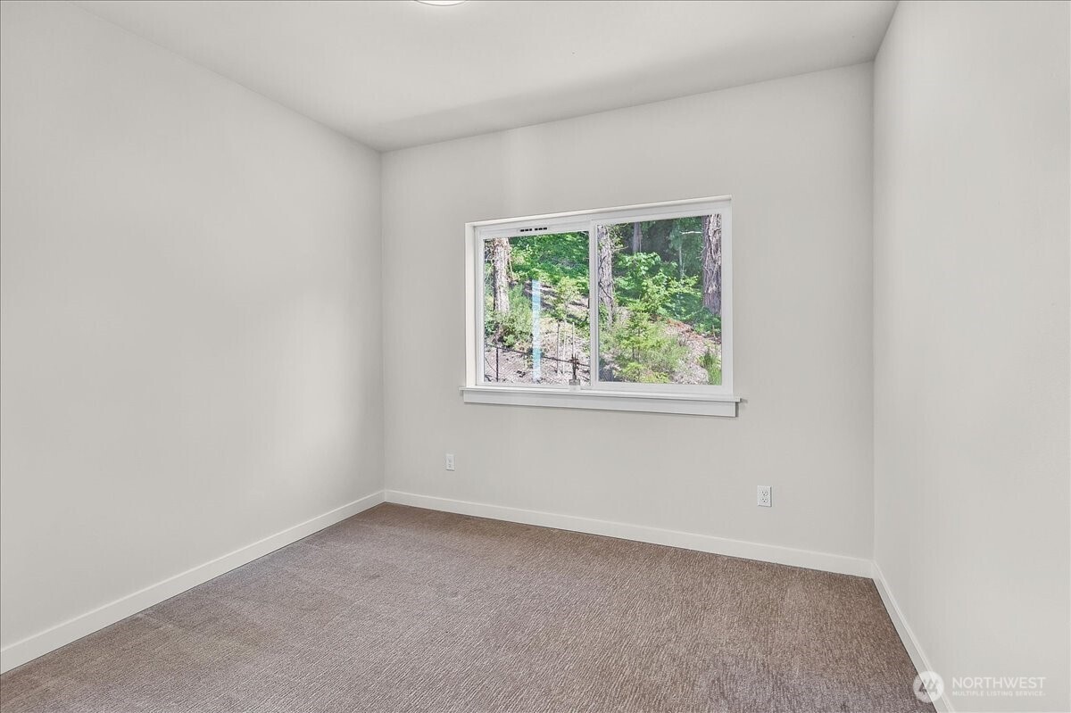 8922 Northeast 173rd Place, Unit A Bothell, WA 98011 - Photo 14 of 26 an empty room with a window