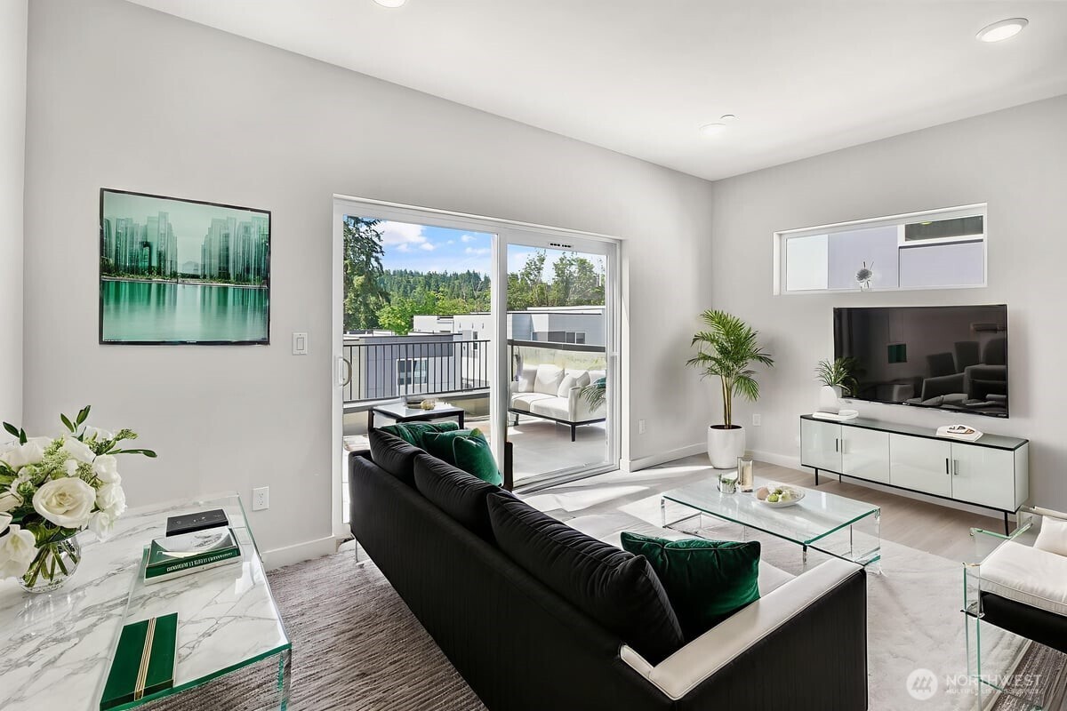 8922 Northeast 173rd Place, Unit A Bothell, WA 98011 - Photo 18 of 26 a living room with furniture and a flat screen tv