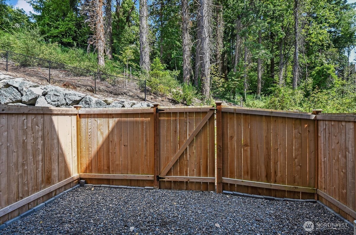 8922 Northeast 173rd Place, Unit A Bothell, WA 98011 - Photo 20 of 26 a view of backyard with green space and wooden fence