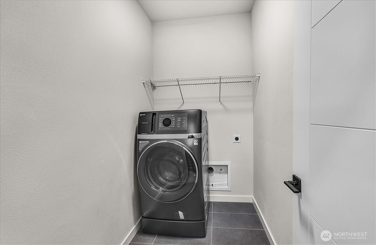 8922 Northeast 173rd Place, Unit A Bothell, WA 98011 - Photo 22 of 26 a view of storage and utility room with washer and dryer