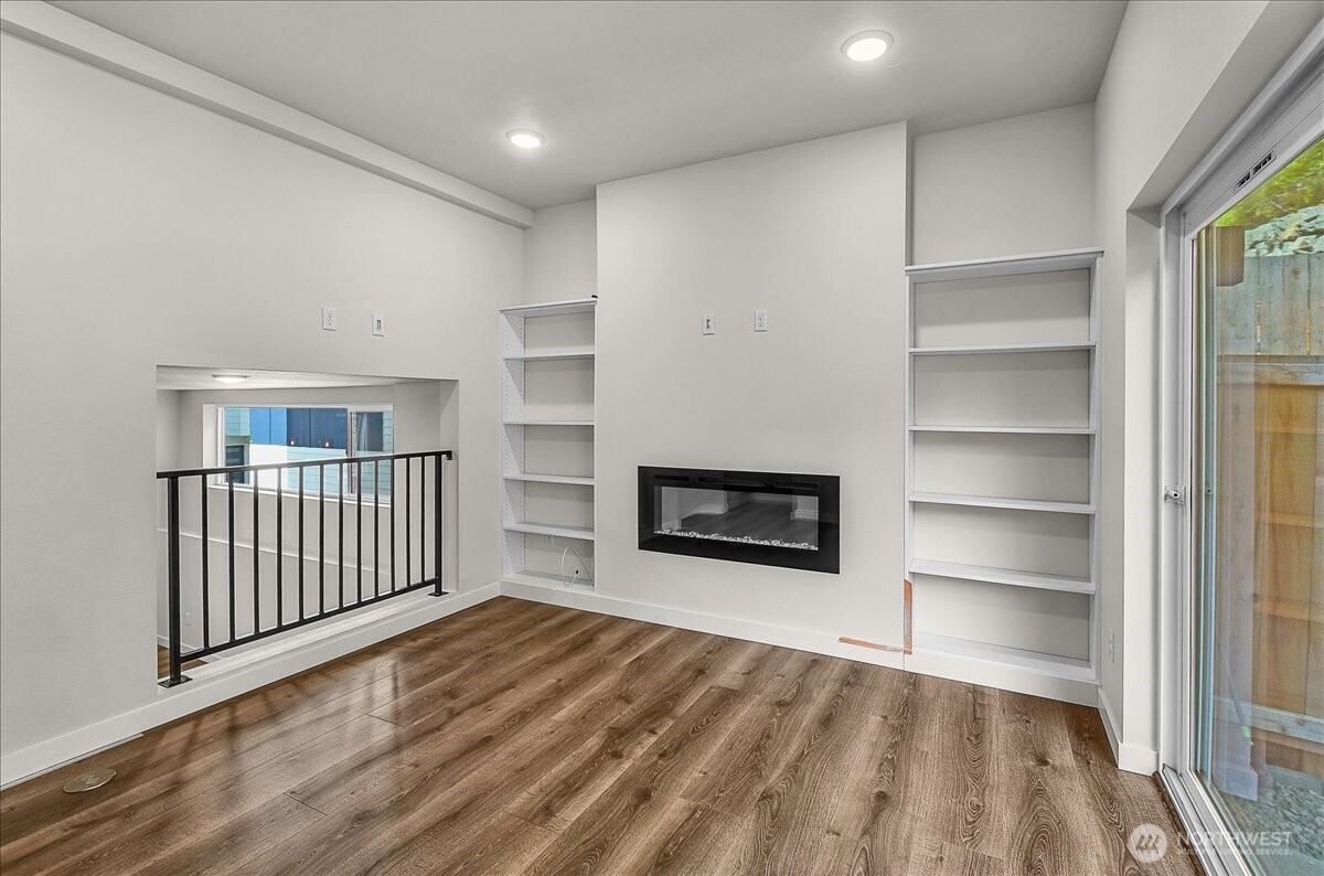 8922 Northeast 173rd Place, Unit A Bothell, WA 98011 - Photo 7 of 26 a view of a livingroom with wooden floor & a staircase