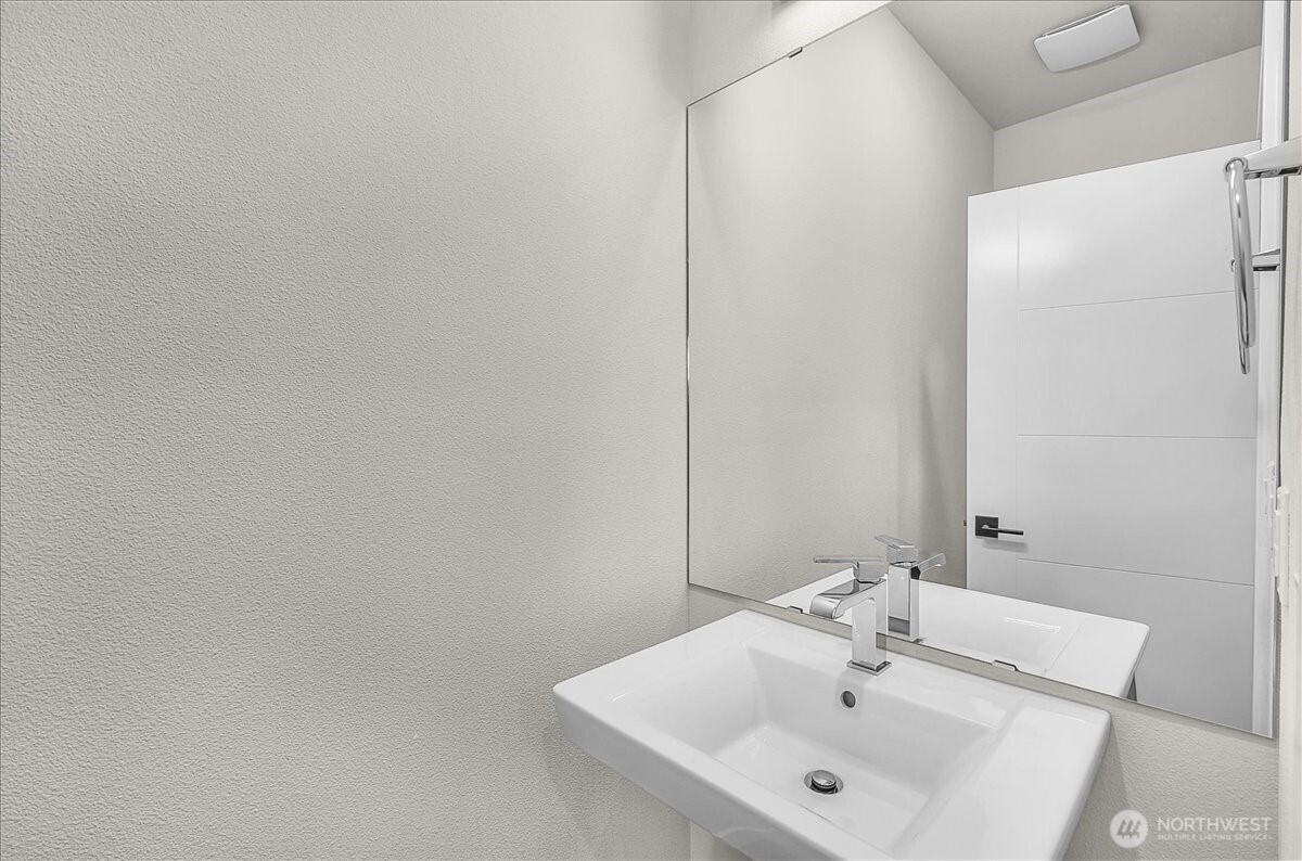 8922 Northeast 173rd Place, Unit A Bothell, WA 98011 - Photo 8 of 26 a bathroom with a sink and a mirror