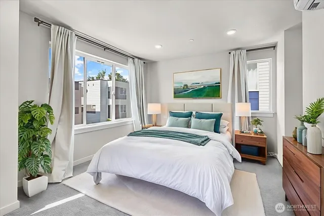 a spacious bedroom with a large bed and a potted plant