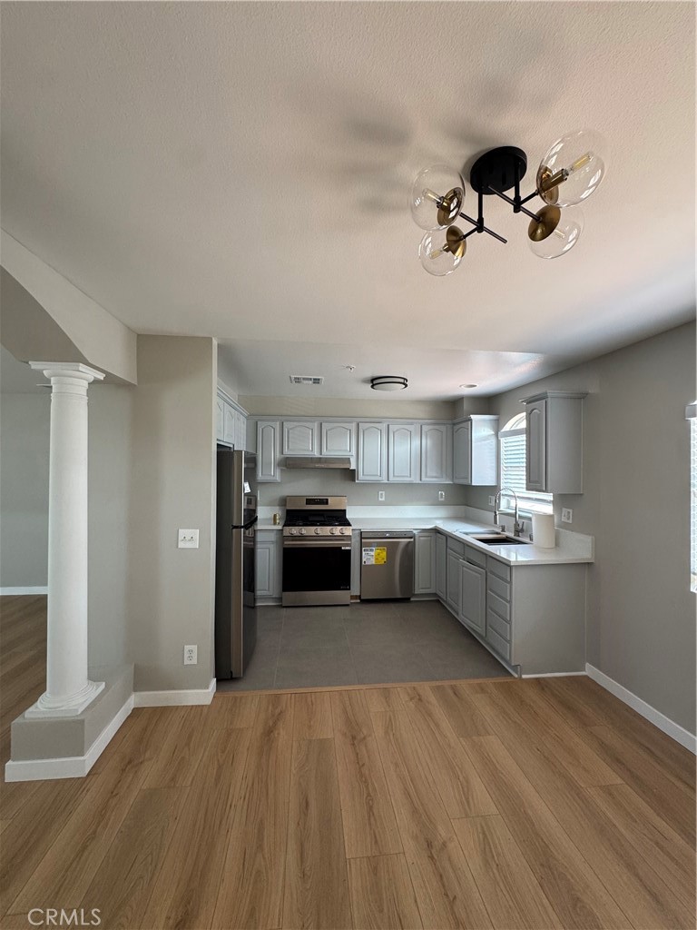 132 North 3rd Street, Unit A Alhambra, CA 91801 - Photo 4 of 15 a kitchen with a refrigerator and white cabinets