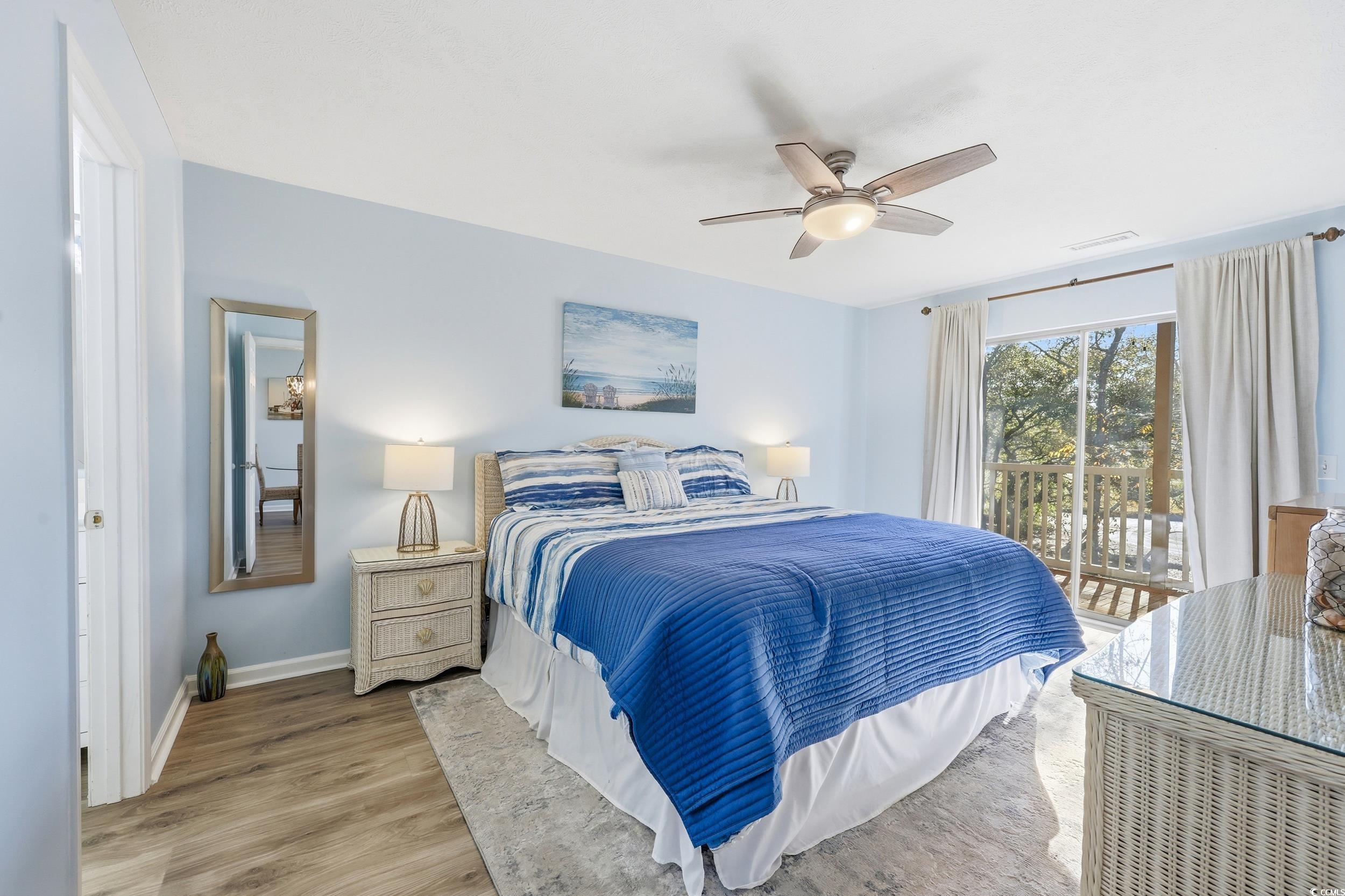 448 Pinehurst Lane, Unit 16F Pawleys Island, SC 29585 - Photo 21 of 31 Bedroom featuring access to exterior, wood finished floors, and a ceiling fan