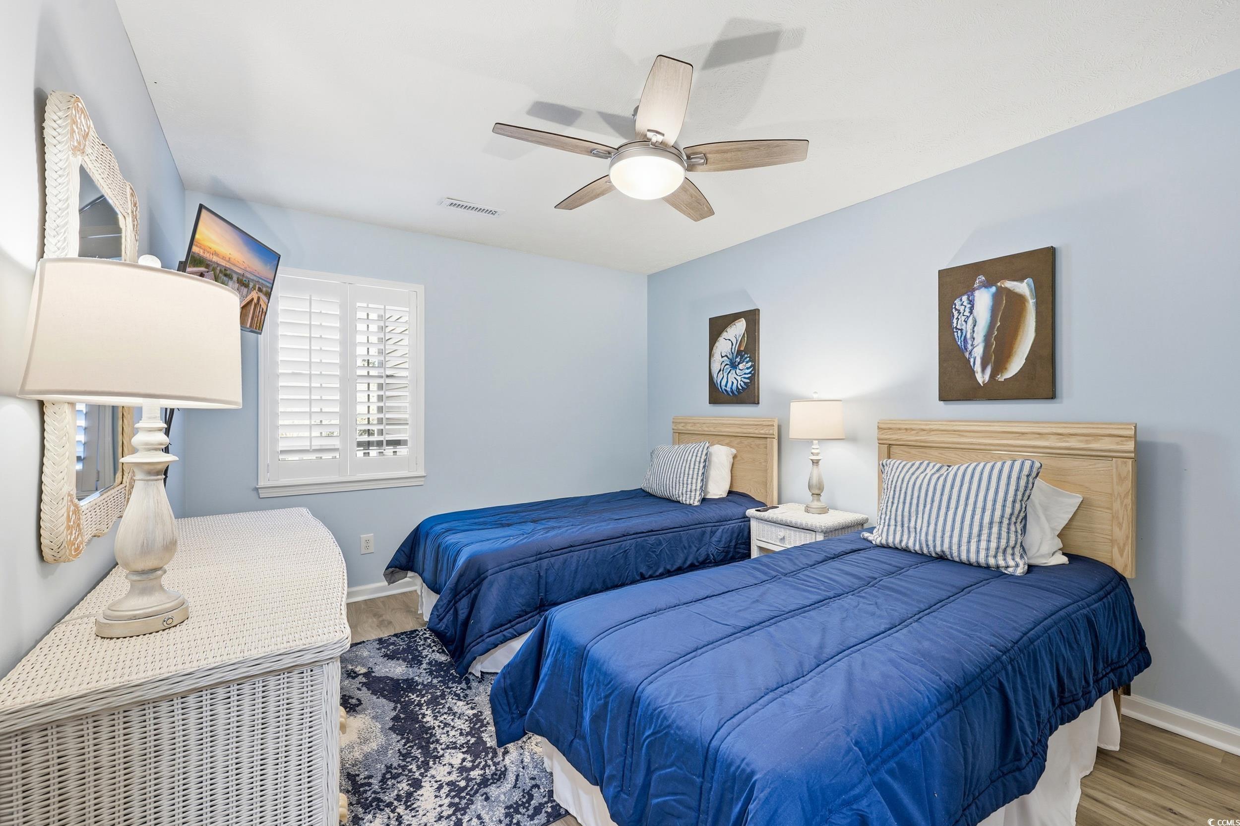 448 Pinehurst Lane, Unit 16F Pawleys Island, SC 29585 - Photo 30 of 31 Bedroom with ceiling fan and wood finished floors