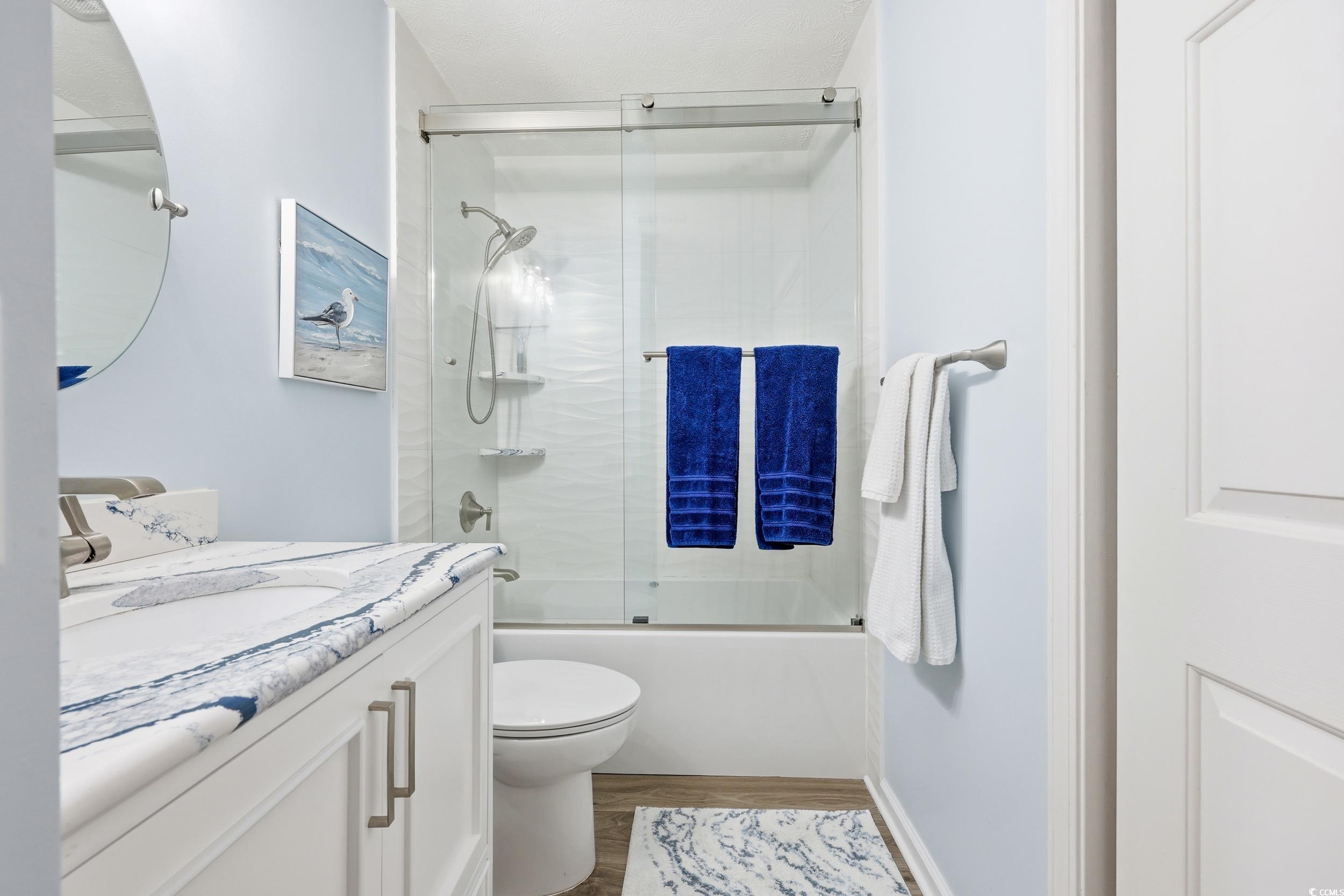 448 Pinehurst Lane, Unit 16F Pawleys Island, SC 29585 - Photo 6 of 31 Bathroom with shower / bath combination with glass door, vanity, and wood finished floors