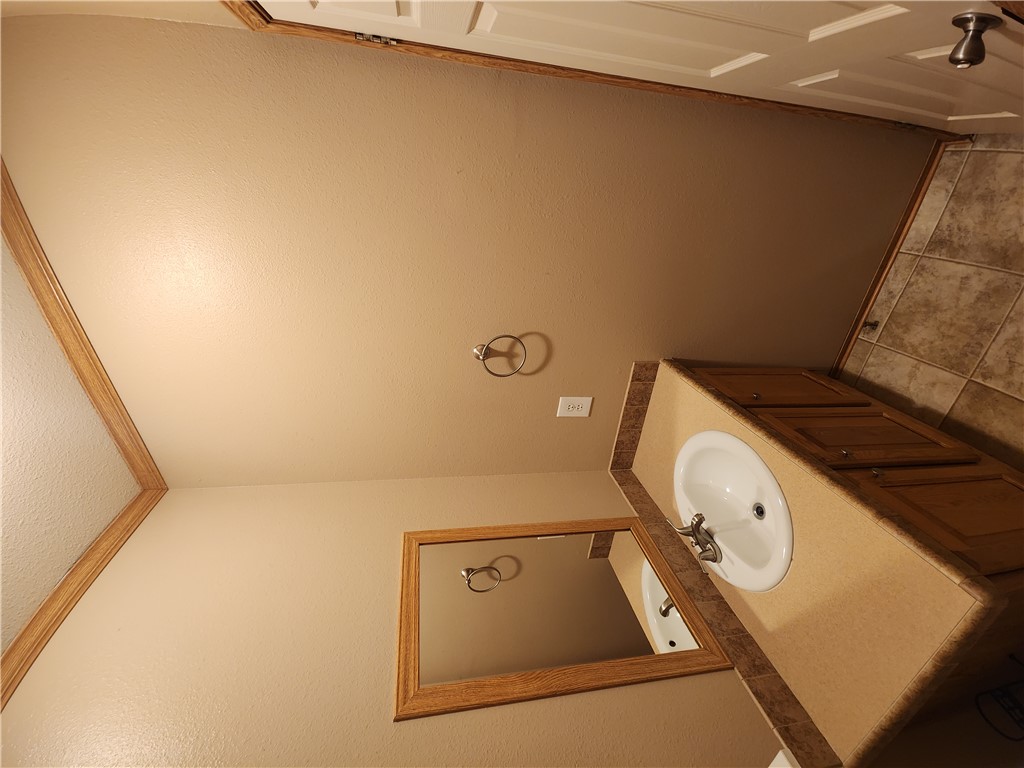 3738 Smetana Road Bryan, TX 77807 - Photo 20 of 29 a bathroom with a sink and mirror with toilet