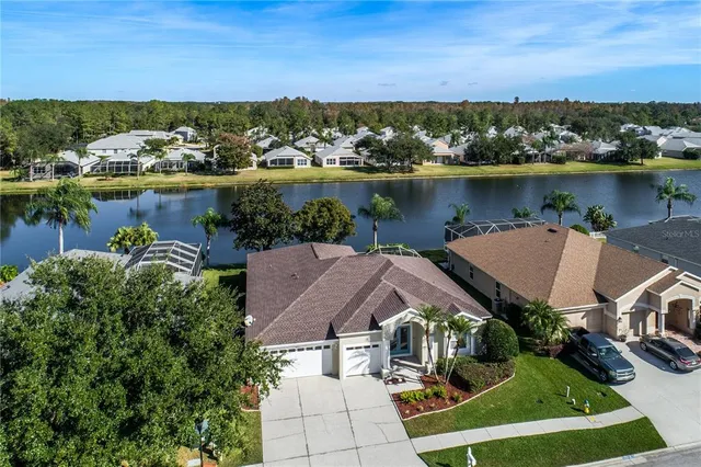 an aerial view of a house with a lake view