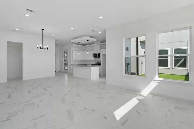 a view of a kitchen with refrigerator and windows