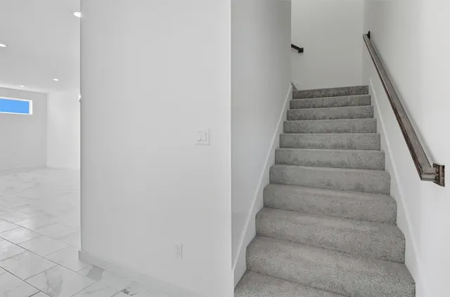 a view of staircase with white walls