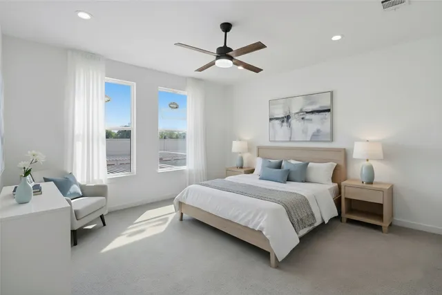 a bedroom with a bed couch and a window