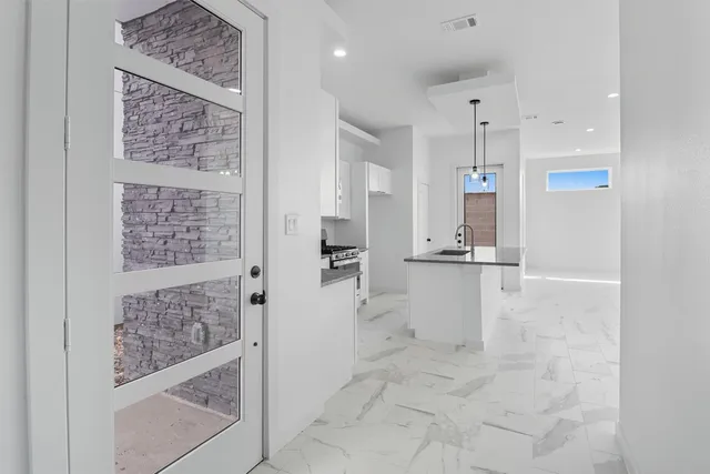a view of kitchen with refrigerator and window