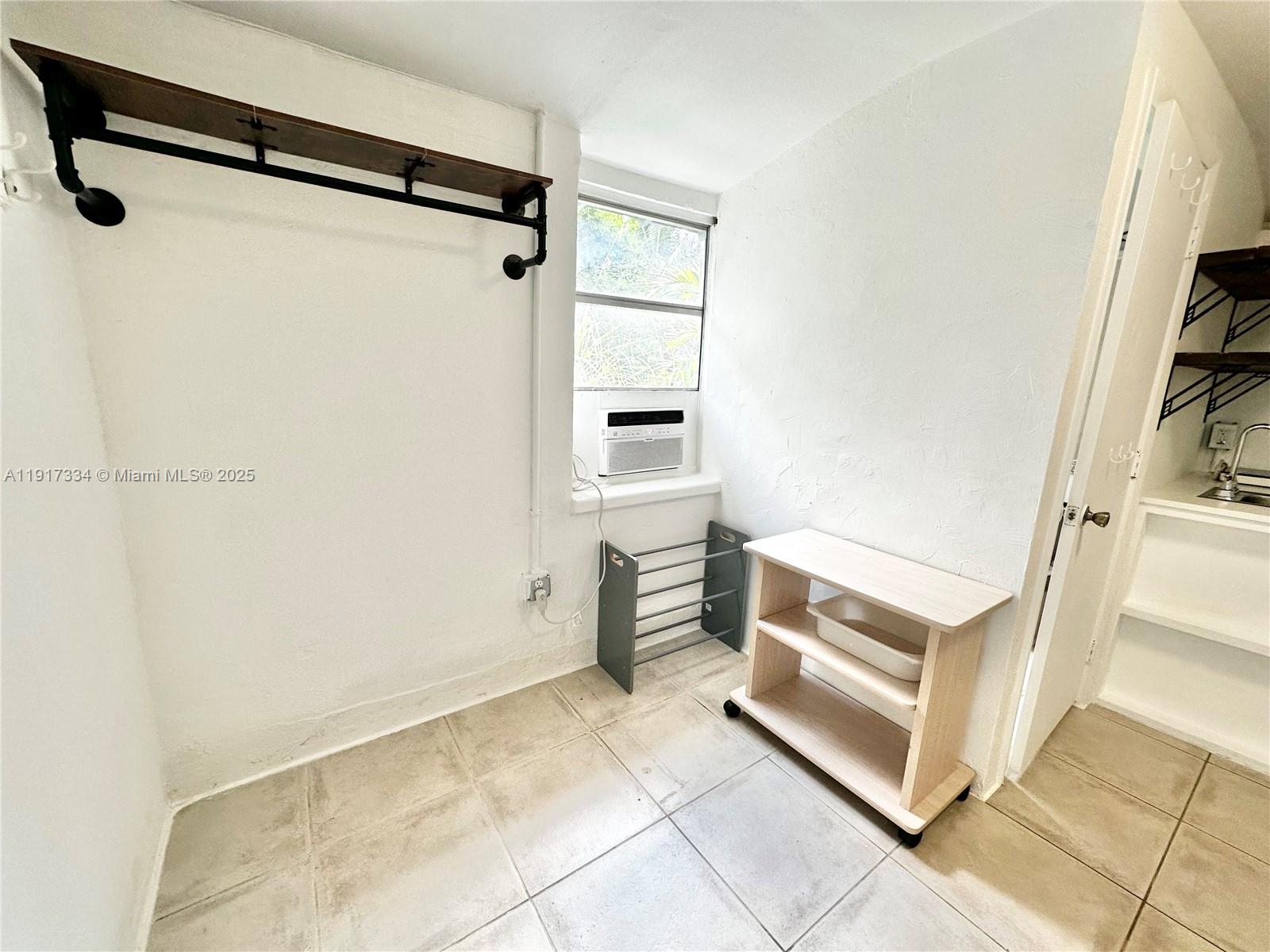 3085 Elizabeth Street, Unit 2 Miami, FL 33133 - Photo 16 of 18 a view of walk in closet with empty racks
