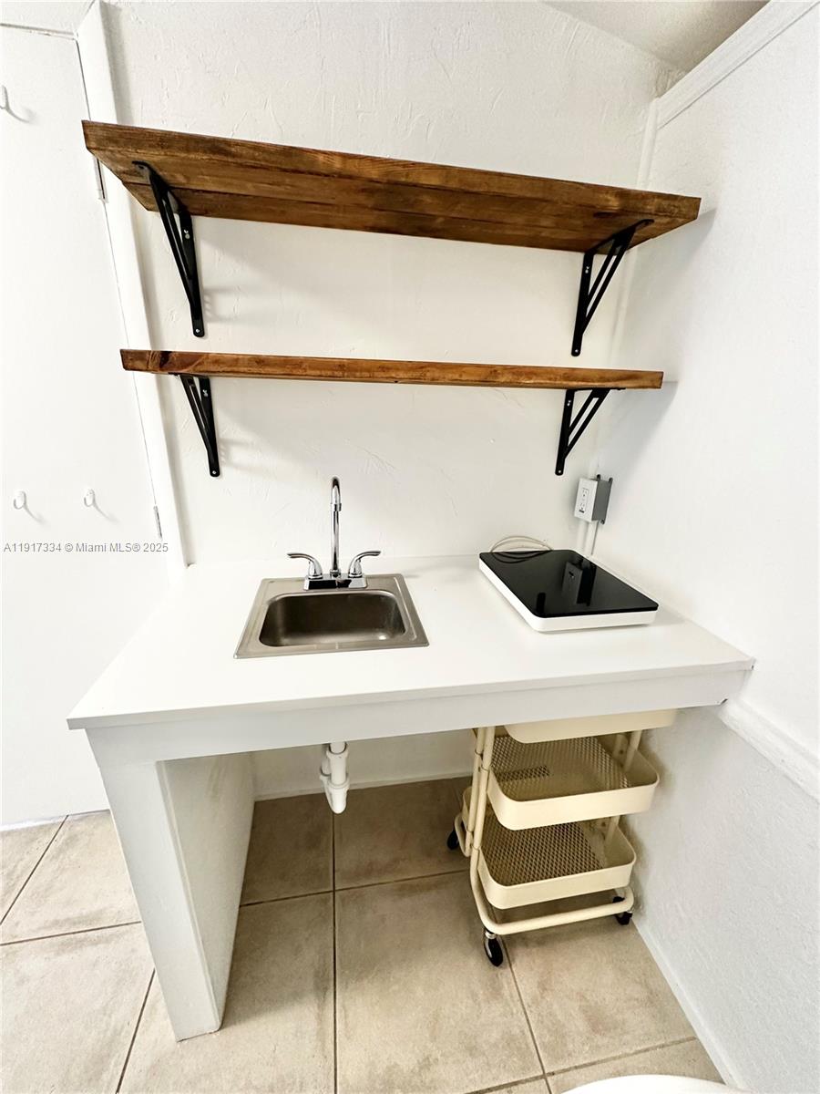 3085 Elizabeth Street, Unit 2 Miami, FL 33133 - Photo 17 of 18 a bathroom with a sink and a mirror