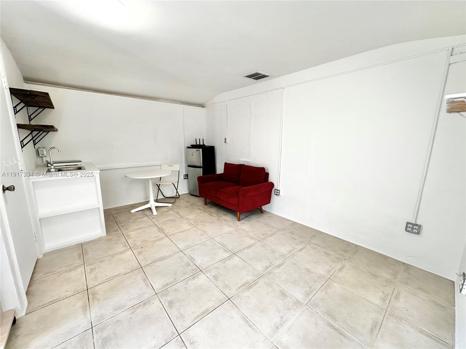 3085 Elizabeth Street, Unit 2 Miami, FL 33133 - Photo 6 of 18 a living room with furniture and a table