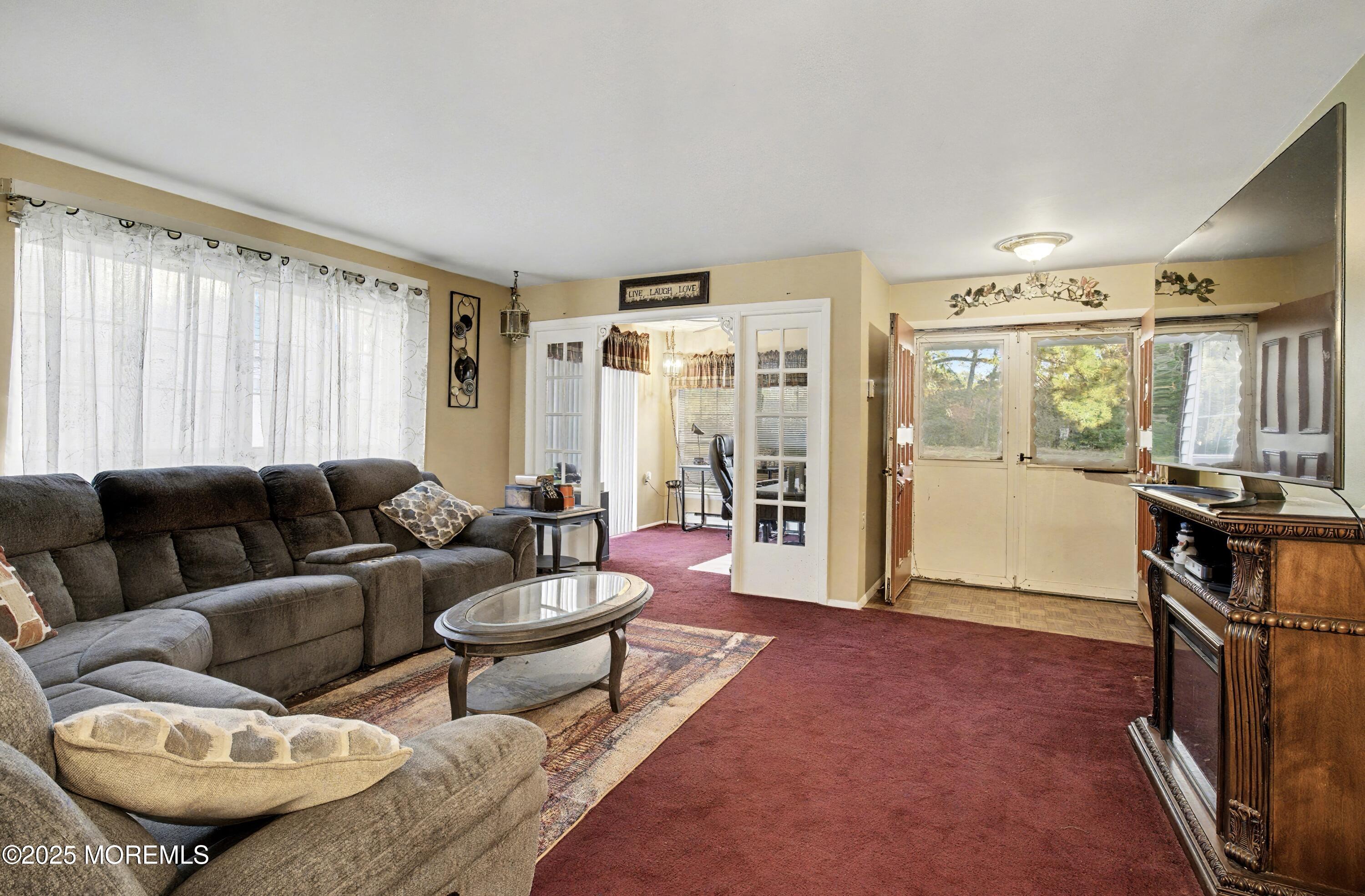 567 A Mayfair Road Manchester Township, NJ 08759 - Photo 13 of 46 a living room with furniture a rug and a large window