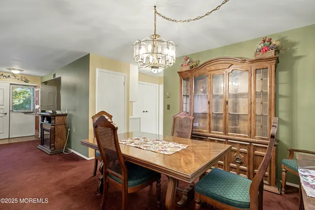 a view of a dining room with furniture and chandelier