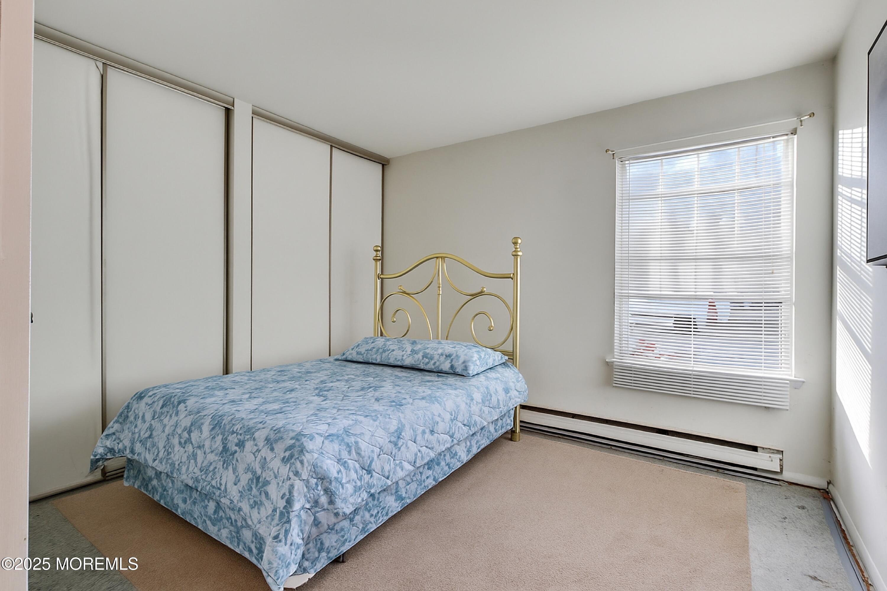 567 A Mayfair Road Manchester Township, NJ 08759 - Photo 23 of 46 a bedroom with a bed and a window