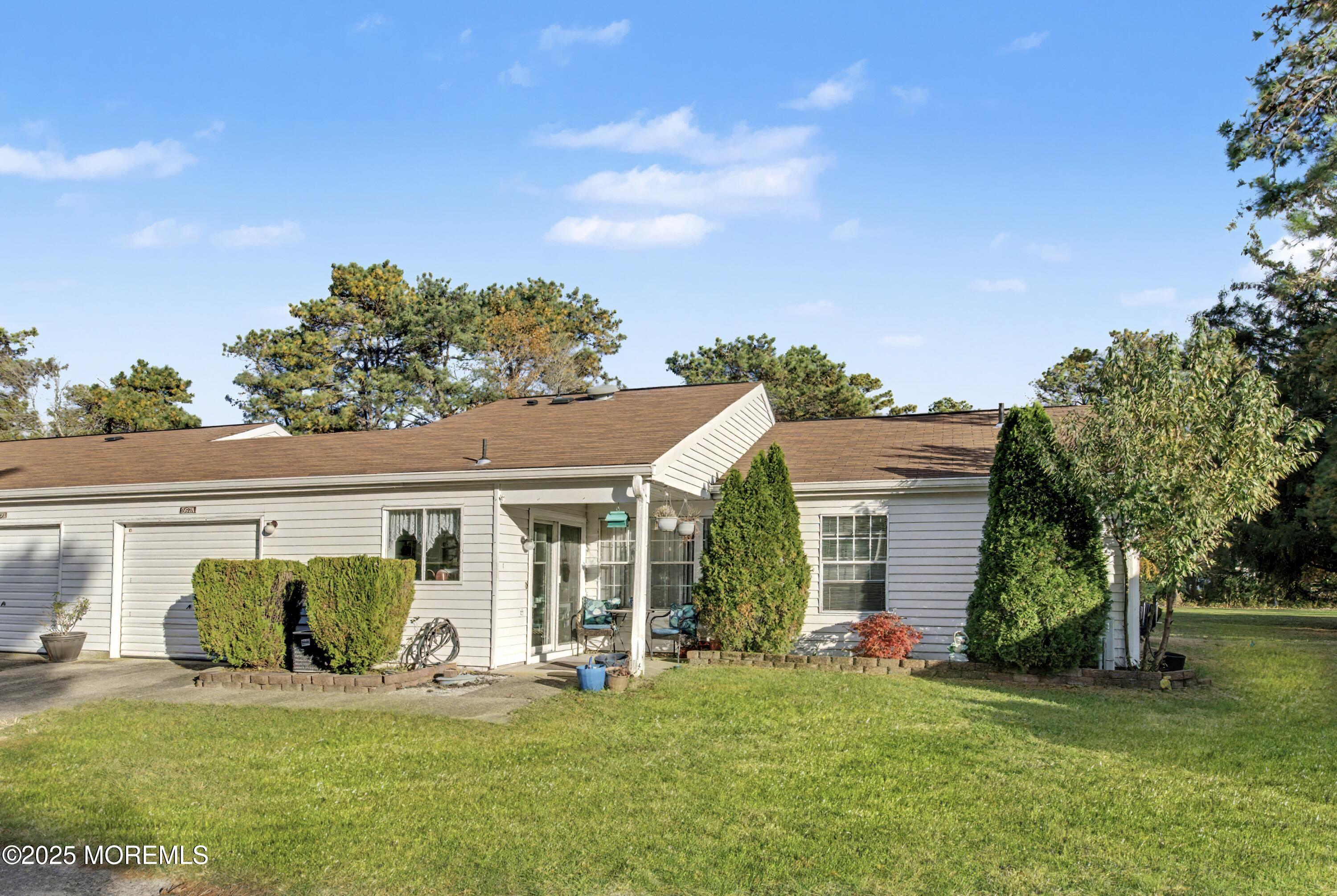 567 A Mayfair Road Manchester Township, NJ 08759 - Photo 3 of 46 a front view of a house with a garden and trees