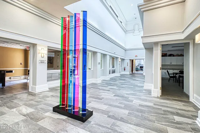 a room with pool table and windows