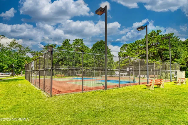 a view of a swimming pool with a lawn chairs under an umbrella