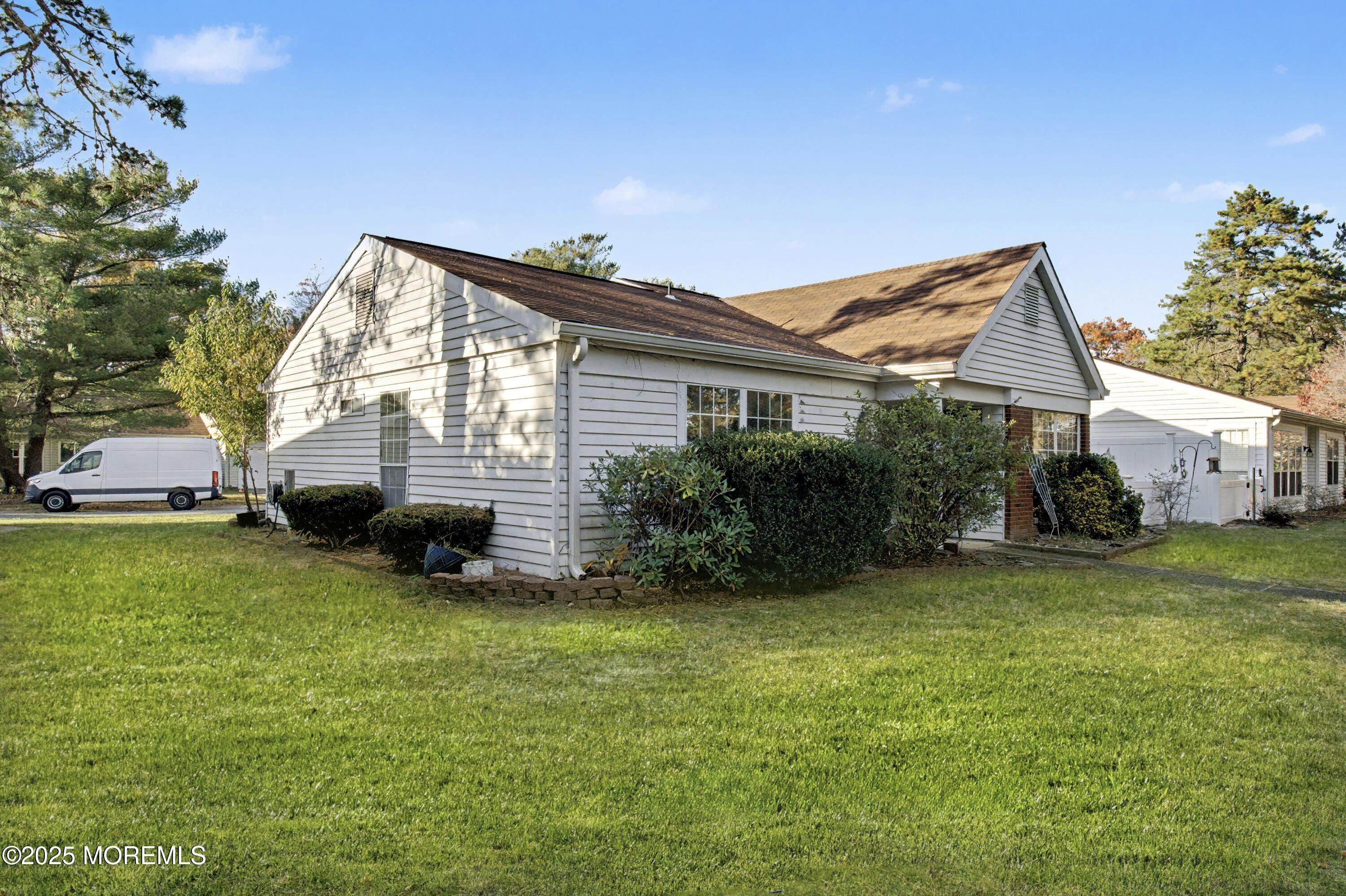 567 A Mayfair Road Manchester Township, NJ 08759 - Photo 4 of 46 a view of a house with a yard and a porch