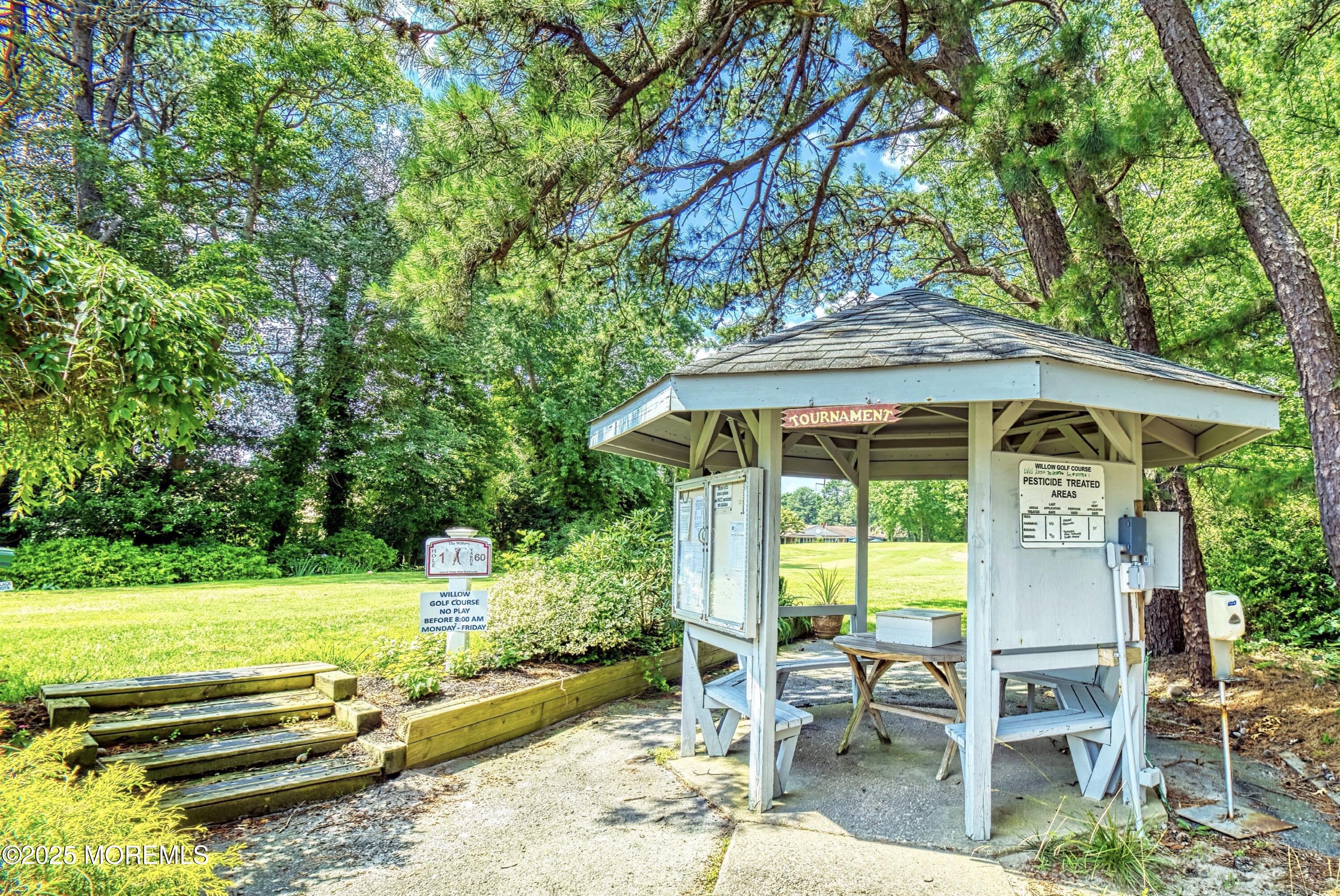 567 A Mayfair Road Manchester Township, NJ 08759 - Photo 46 of 46 a view of backyard with a table and chairs under an umbrella
