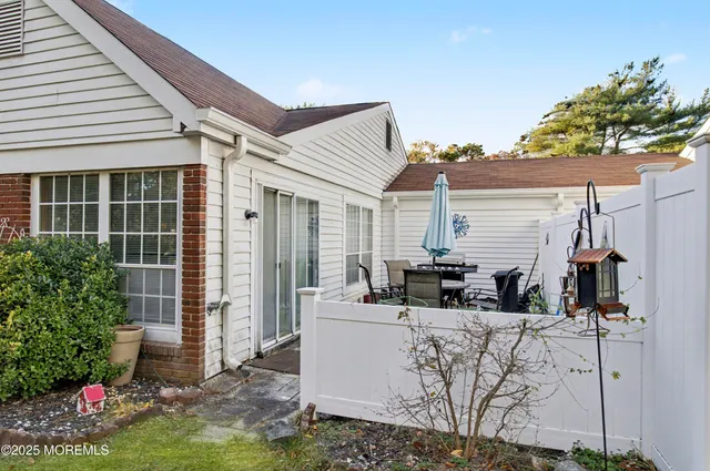 a large white kitchen with stainless steel appliances granite countertop lots of white cabinets