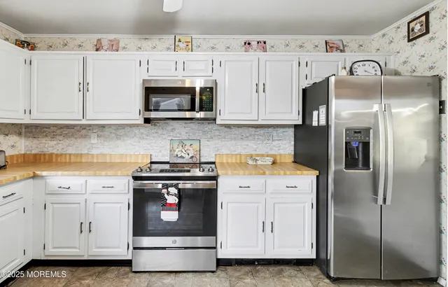 a kitchen with a sink stove and microwave
