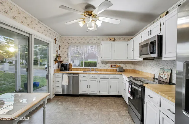 a room with a refrigerator and a stove top oven