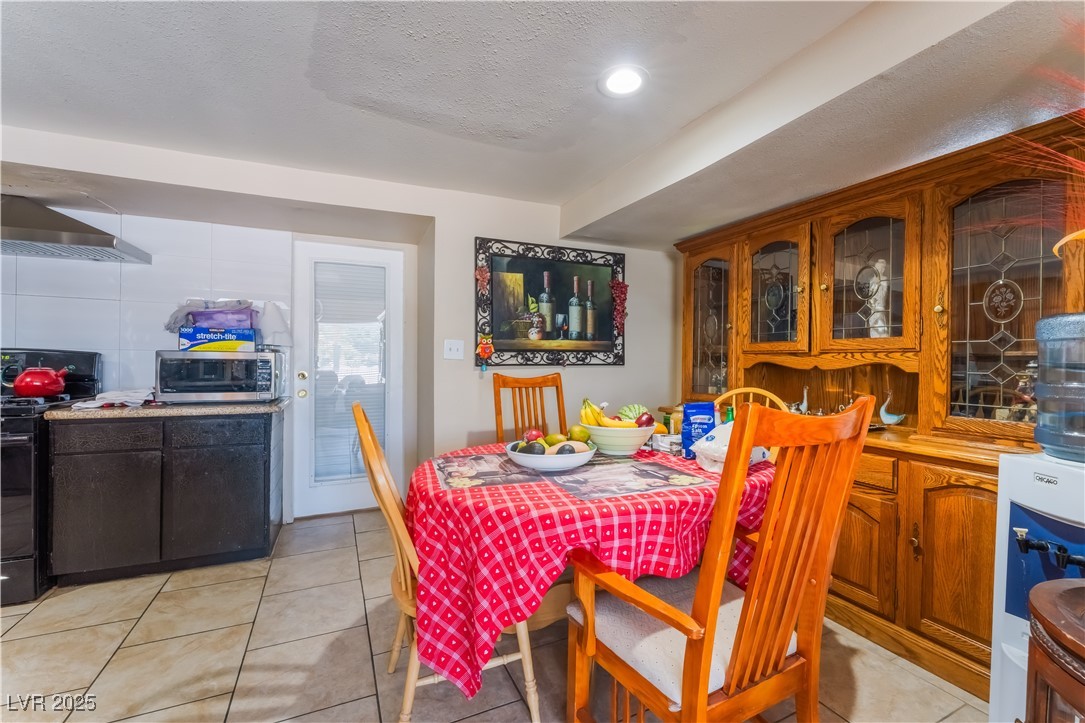 1908 Ardmore Street Las Vegas, NV 89104 - Photo 12 of 29 Dining area with light tile patterned floors and a textured ceiling