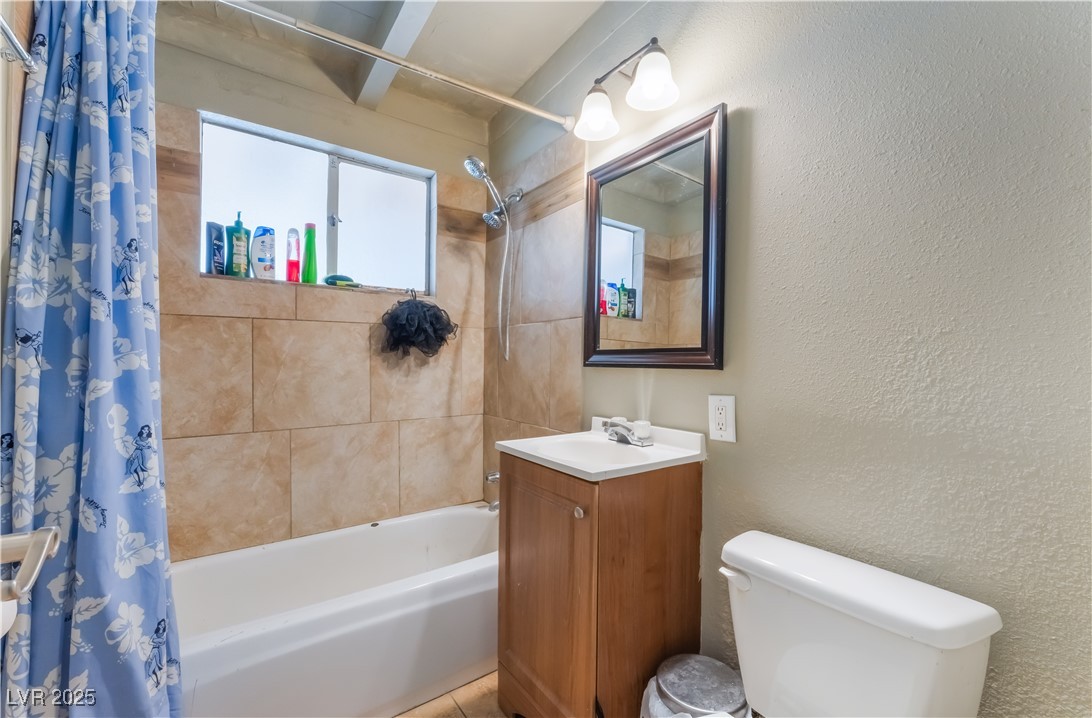 1908 Ardmore Street Las Vegas, NV 89104 - Photo 16 of 29 Bathroom with shower / tub combo, vanity, and a textured wall